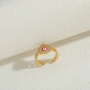 Macro view of 14K gold plated evil eye ring with red enamel and sparkling zircons