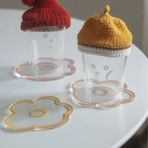 Nordic flower acrylic coasters in orange and yellow, minimalist heat-resistant clear trays