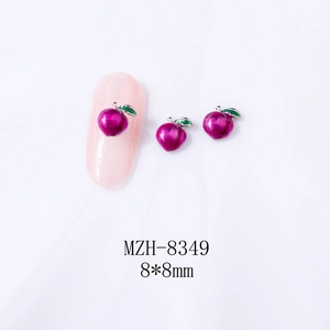 Detail showing 8x8mm peach nail charm with pink enamel and green leaf on nail tip