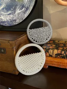 Detail of handcrafted beaded round handbags in pearl and rhinestone finishes on vintage props