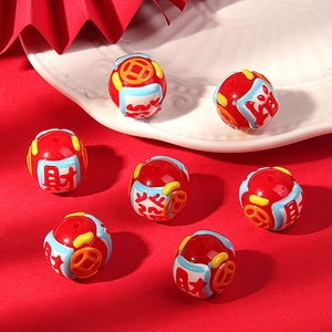Macro shot of red DIY craft beads featuring Chinese fortune characters and coin patterns