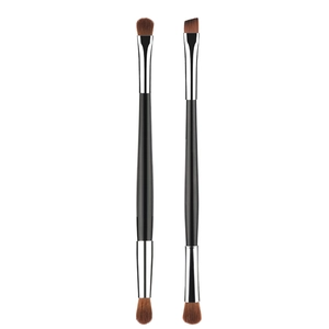 Detail of dual-ended eyeshadow and eyebrow brushes with silver ferrules and soft bristles