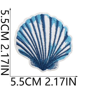 Detail showing shell-shaped embroidered patch with blue and white stitching, size 5.5cm