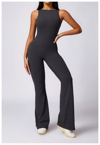 Charcoal grey backless yoga jumpsuit with flared pants showing sleek athletic fit