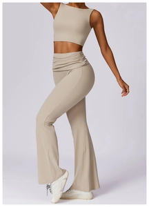 Side view of beige yoga set featuring a cropped tank top and high-waisted flared pants