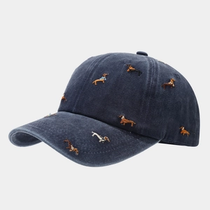 Detailed view of embroidery featuring diverse dachshund dogs on navy washed cotton cap