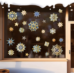 Detailed close-up of blue and gold snowflake static window stickers on festive glass decor