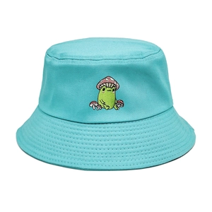 Close-up of a frog sitting among mushrooms embroidery on a teal cotton bucket hat