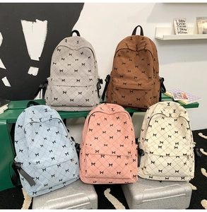 Detail of corduroy backpacks in five colors with cute black bowknot patterns