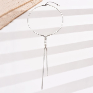 Detailed view of polished silver snake chain necklace in a Y-shaped tie knot design