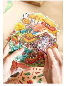 Detail of tweezers placing 3D Chinese courtyard stickers for DIY miniature crafts