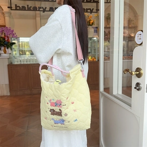 Quilted yellow tote bag with cartoon cat embroidery and adjustable pink shoulder strap