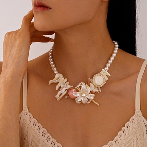 Close-up of a resort-style floral necklace with imitation pearls and shell flower charms