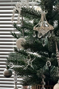 Detail of crystal glass ornaments and glitter balls hanging on a Christmas tree