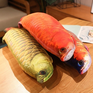 Detailed view of three 3D digital printed fish plush pillows on a wooden table