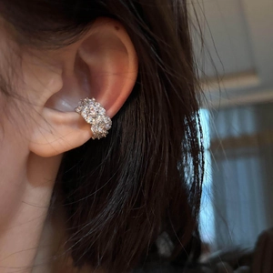 Elegant silver zircon flower ear cuff for non-pierced ears shown on a model ear