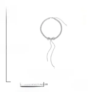 Detail showing crystal bow pendant and tassels with size parameters 35cm plus 7.5cm
