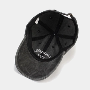 Detail view of washed cotton baseball cap interior with 100% cotton label and metal buckle