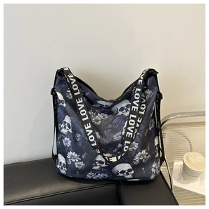 Detail of nylon tote bag featuring blue skull floral patterns and LOVE strap