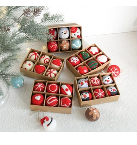 Detail of Christmas wool felt ornaments in a gift box with pine and festive lights