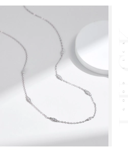 Close-up of minimalist S925 silver choker with sparkling zircon clusters on O-chain