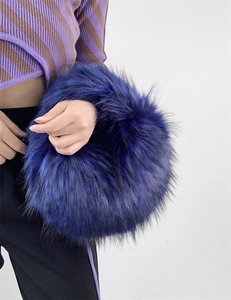 Detailed view of the blue faux raccoon fur fluffy spherical handbag in Y2K punk style