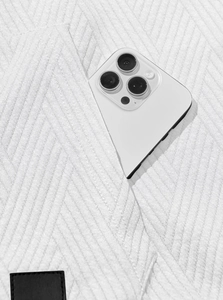 Close-up of herringbone texture on white sleeveless hoodie with functional pocket detail