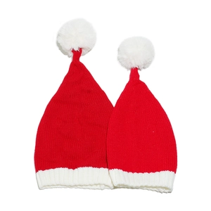 Family set of red and white knit Christmas hats with plush pom-poms on plain white background