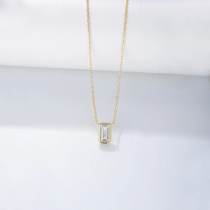 Detailed macro view of the gold S925 silver necklace with emerald-cut zircon pendant