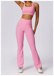 Detail of pink high-elastic yoga set featuring a racerback bra and flared leggings