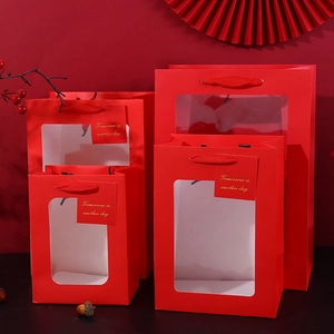 Red festive gift bags with transparent windows and braided handles in various sizes