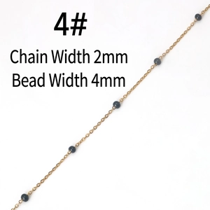 Detail view of 2mm golden stainless steel chain with 4mm dark grey beads for DIY jewelry