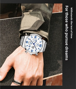 Close-up of blue luminous hands and indices on a white dial men's sport watch