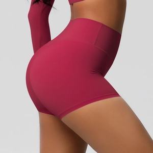 Detail of high-waisted yoga shorts in deep red fabric showing butt-lifting and slimming effect