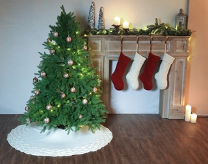 Close-up of white cable-knit Christmas tree skirt with textured chunky weave details