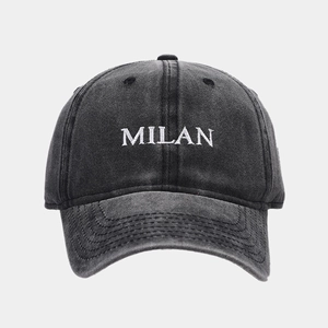 Detailed close-up of MILAN letter embroidery on vintage washed cotton baseball cap