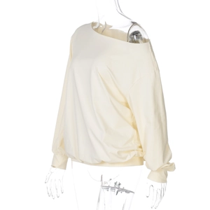 Detailed side view of beige off-shoulder long sleeve cropped top with ribbed cuffs