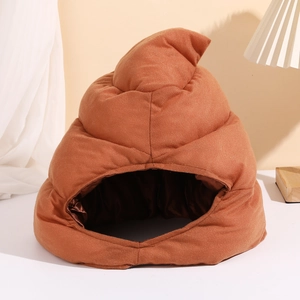 Funny brown poop-shaped plush pet house and hat displayed on a white table in bright room