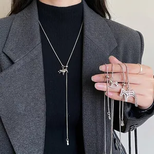 Modern silver horse pendant tassel necklace set with adjustable Y-chain on a black sweater