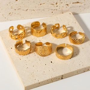 7-piece gold stainless steel ring set with various minimalist patterns on stone base