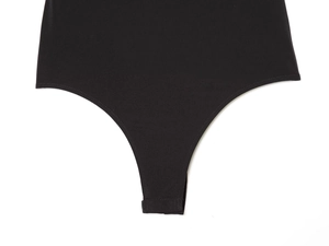 Detail view of the secure snap button closure and stitching on the black bodysuit gusset