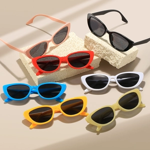 Retro cat-eye sunglasses collection with colorful plastic frames on aesthetic stone props