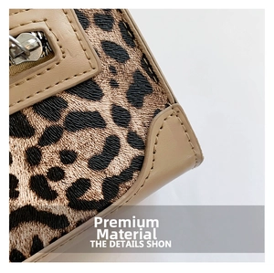 Detailed macro view of leopard print fabric with beige leather trim and silver zipper