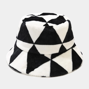 Close-up of plush faux fur fabric texture and geometric triangle patterns on bucket hat