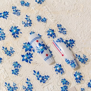 Blue and white floral nail art stickers with elegant embossed porcelain patterns