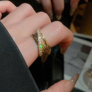 Macro detail of gold triple-layered criss-cross ring with micro-pave cubic zirconia