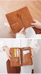 Brown leather passport wallet interior details showing card slots and SIM holder