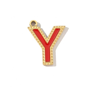 Detail of a vintage golden metal letter Y pendant with red enamel and bead edge
