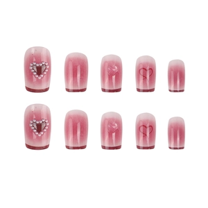 Pink gradient press-on nails with heart pearl designs and 3D embossed heart patterns