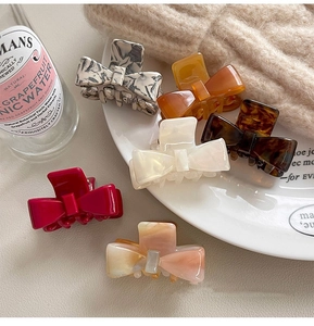 Close-up of assorted acetate bow hair claws in marble, tortoiseshell and amber patterns